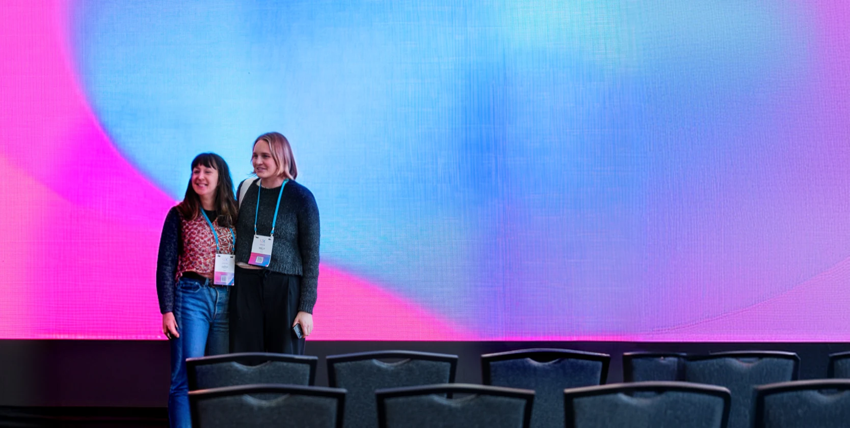 Holly Feary, Senior Product Designer, FarmIQ, on stage at a conference