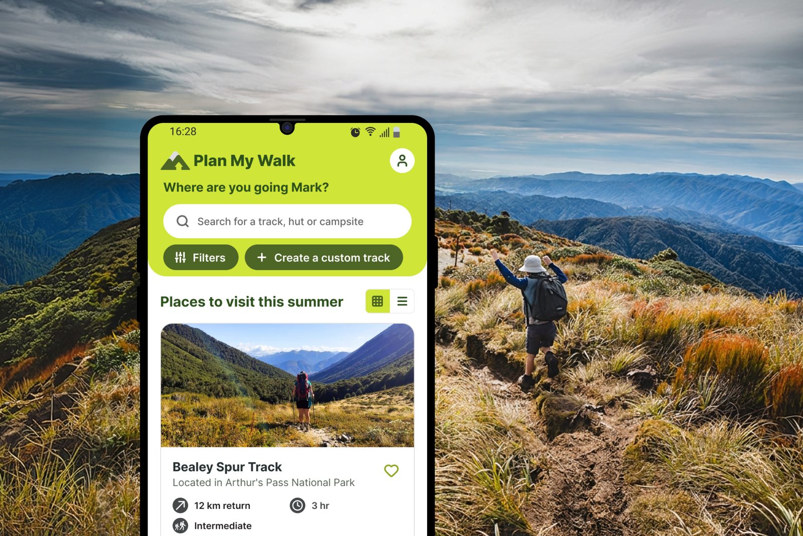 The Plan My Walk home screen on a phone over a tussock ridge, a tramper with arms raised behind it